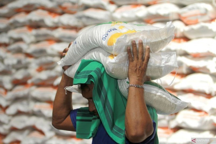 Record stockpile: A worker carries government rice aid on March 3, 2024, at the warehouse of state-owned food logistics company, Bulog, in Talumolo village, Gorontalo city, Gorontalo.