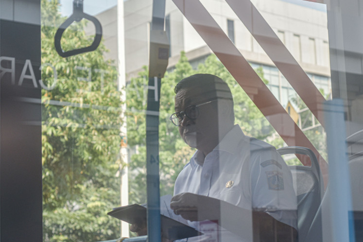 Jakarta Governor Pramono Anung rides a Transjakarta bus in Salemba, Central Jakarta, on April 30, 2025. The city administration requires civil servants to use public transportation every Wednesday in accordance with Gubarnatorial Instruction No. 6/2025.