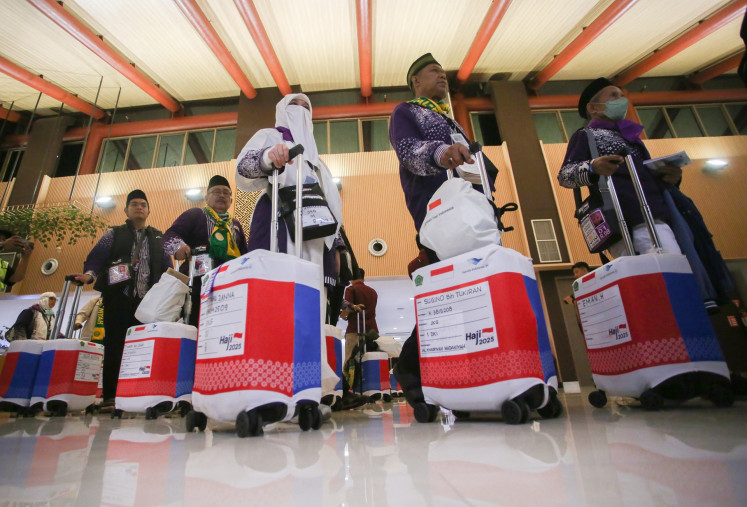 Haj pilgrims walk to the departure terminal at Soekarno-Hatta International Airport in Tangerang, Banten, on May 1, 2025, ahead of their flights to Prince Mohammad bin Abdulaziz Airport in Medina, Saudi Arabia. 